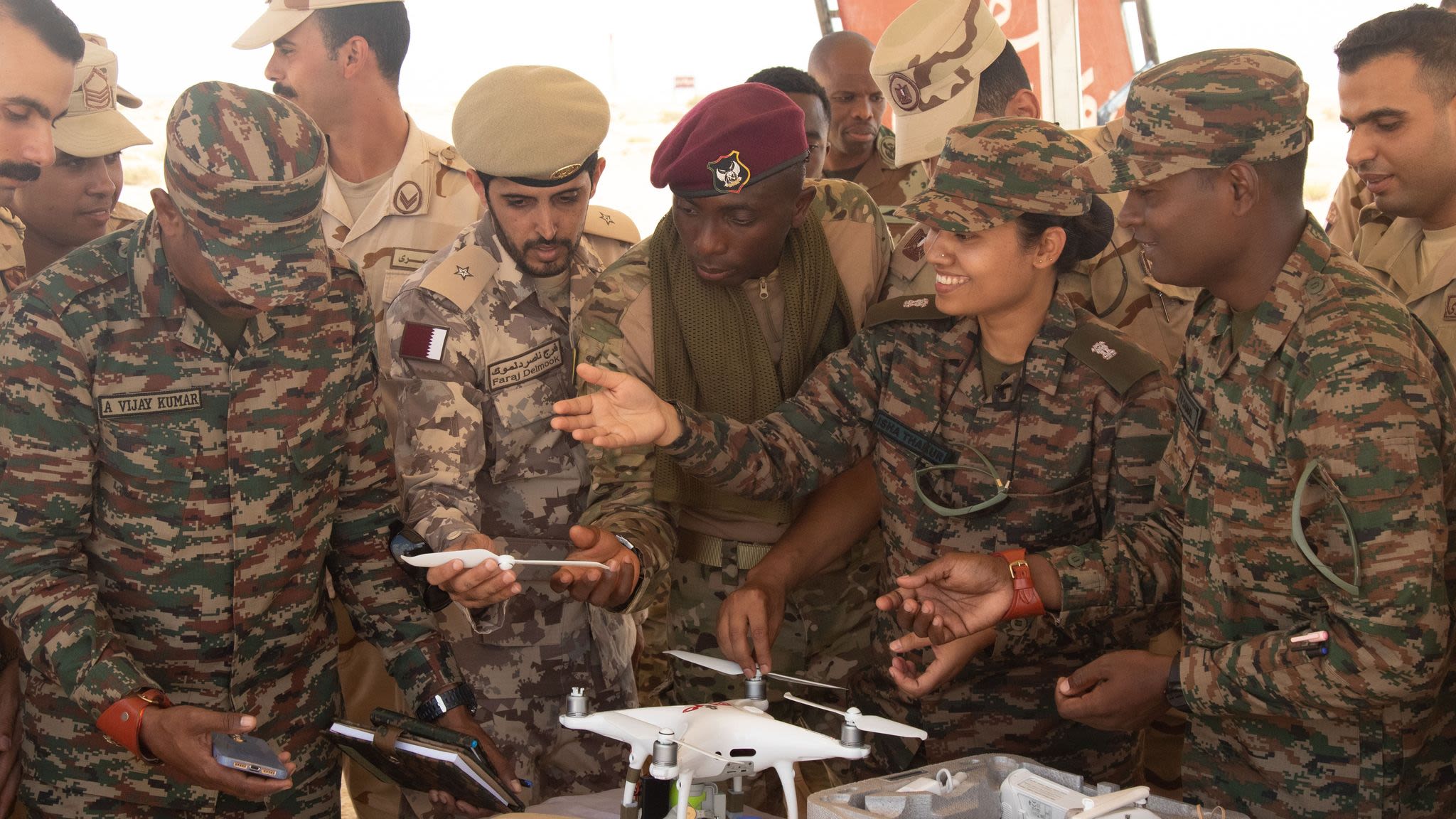 Indian, South African and Qatari soldiers discuss the use of drones in military.