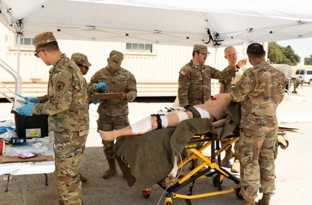 Soldiers with medical mannequin patient