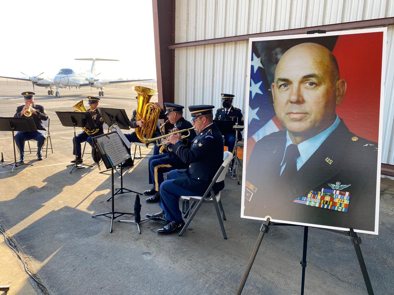 Portrait displayed adjacent to military band plays.