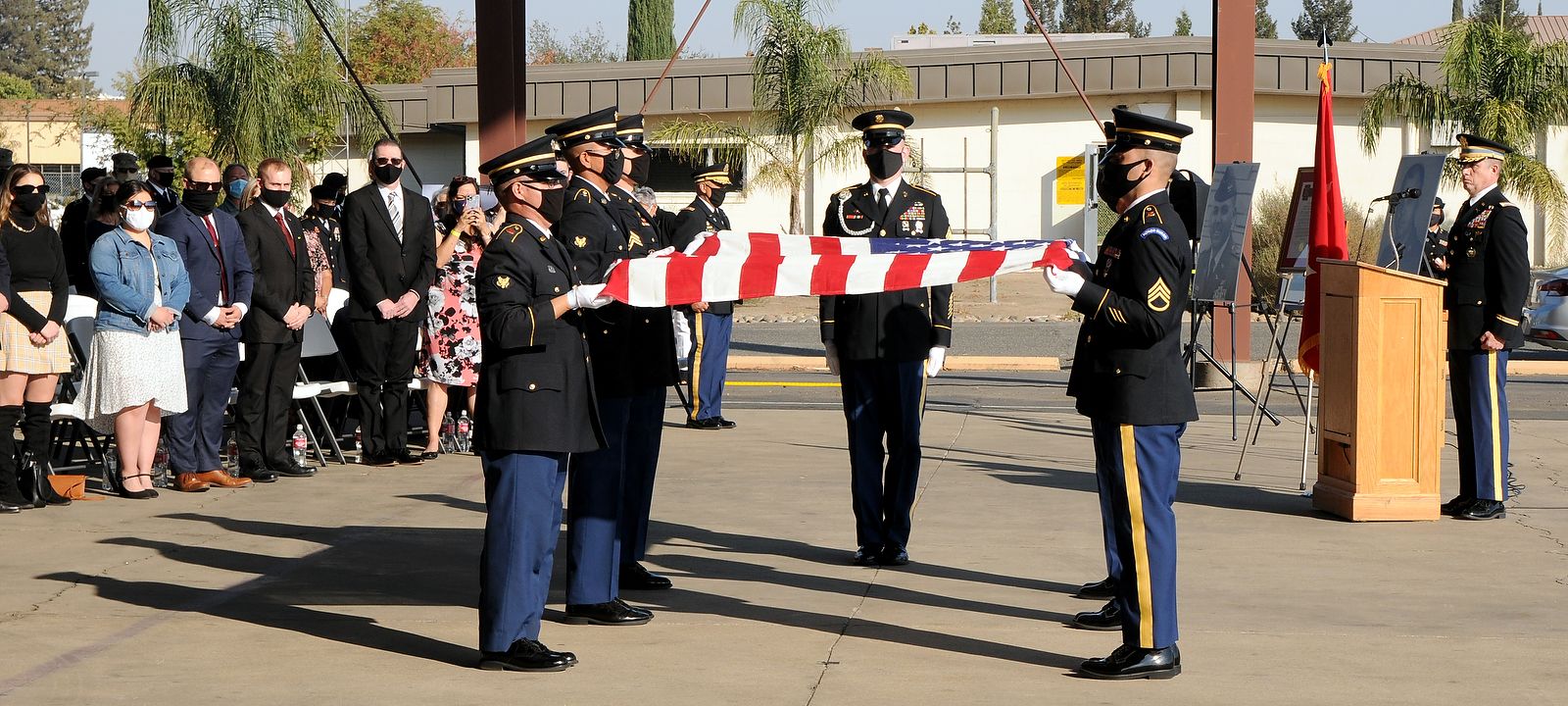 Honor guard folds a flag.