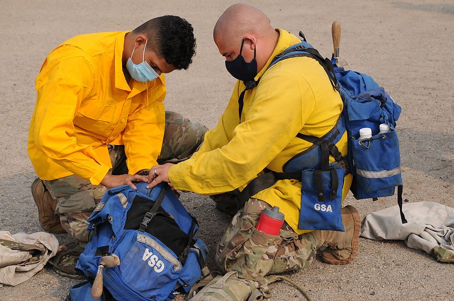 Soldiers pack personal firefighting equipment.