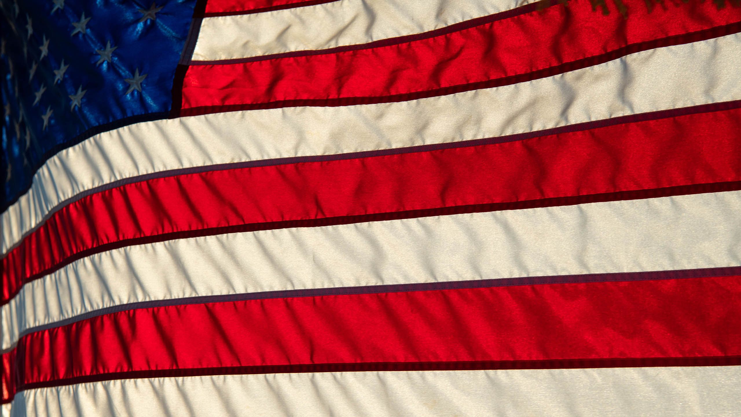 Sunlight shines through American flag.