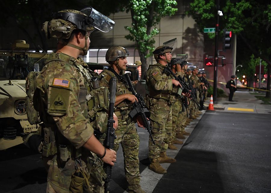 Armed soldiers stand on city streets