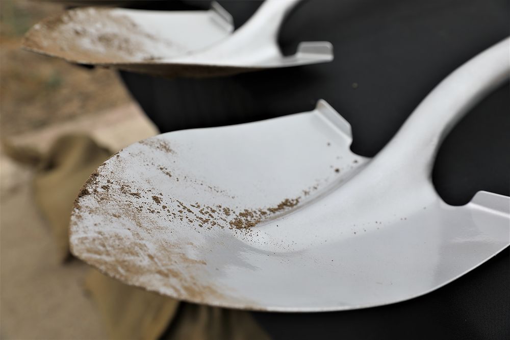 Shovel with dirt on it.