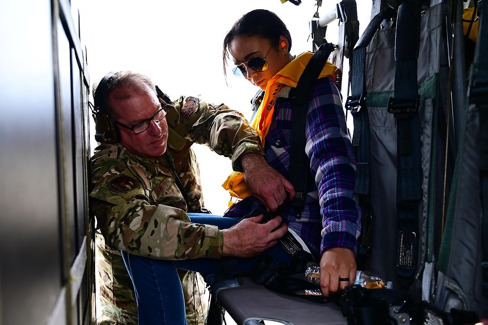 Airman checks seatbelt.