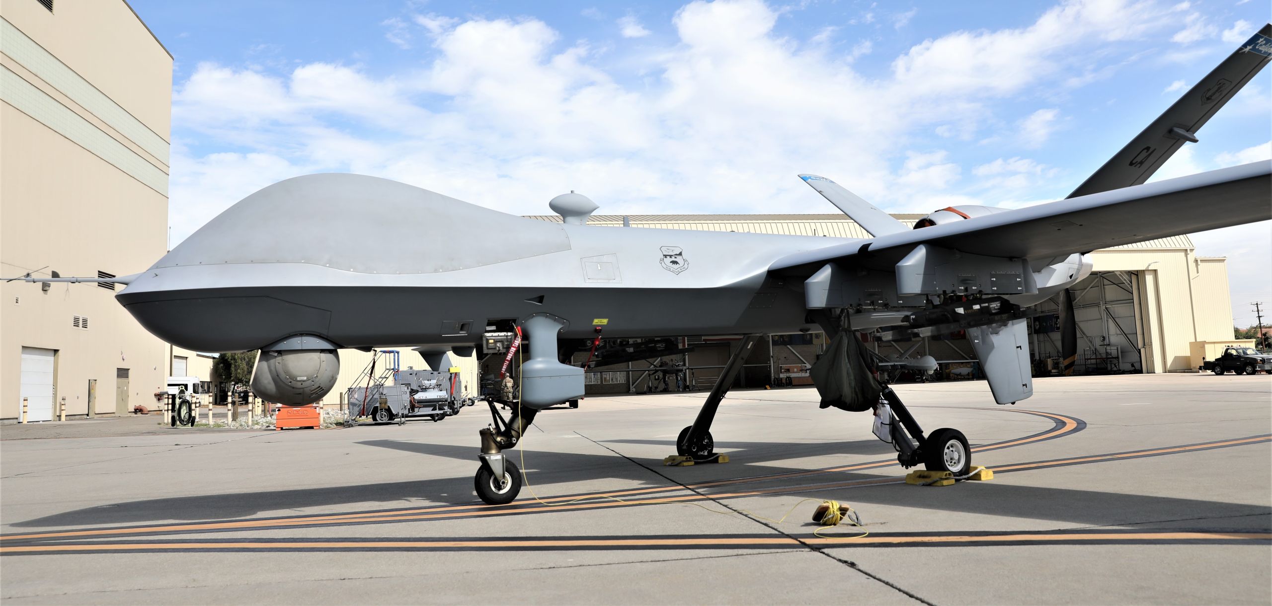 A remotely piloted aircraft sits on a park line.