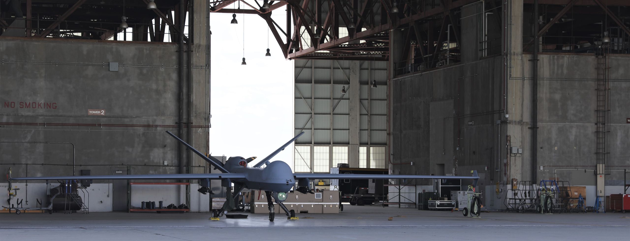 A remotely piloted aircraft sits in a hangar bay.