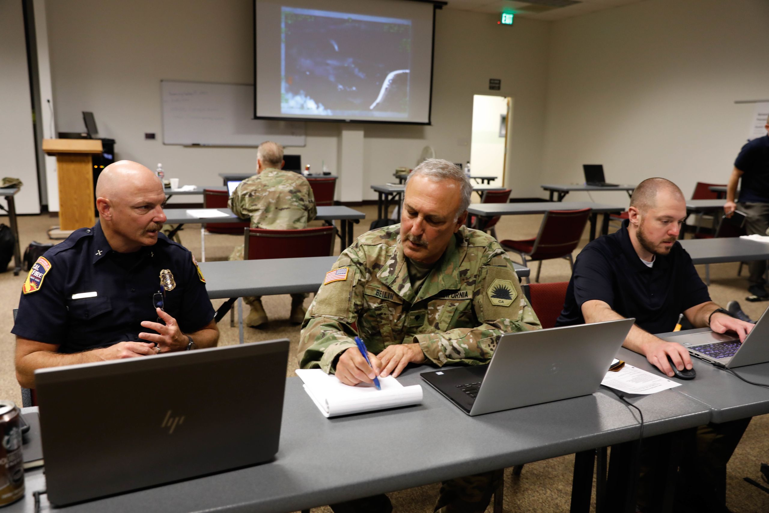 Three men at laptop computers.