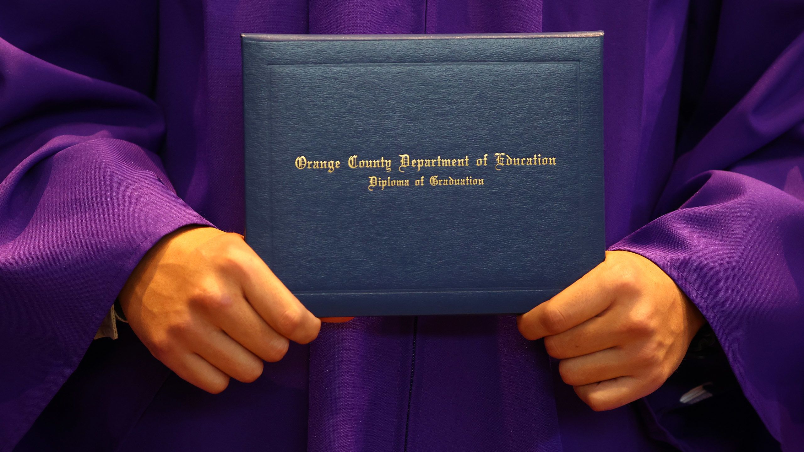 Graduate holds diploma.