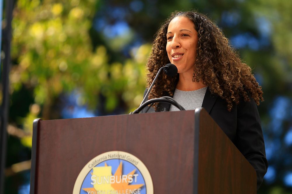 Woman speaks at podium.