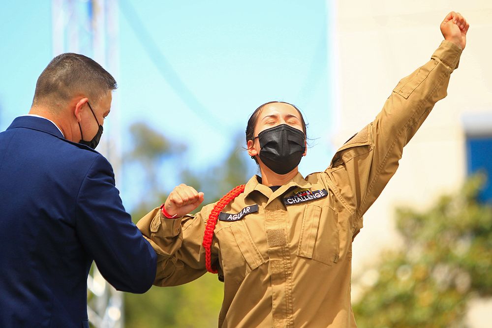Cadet reaches hand in the air as celebration.