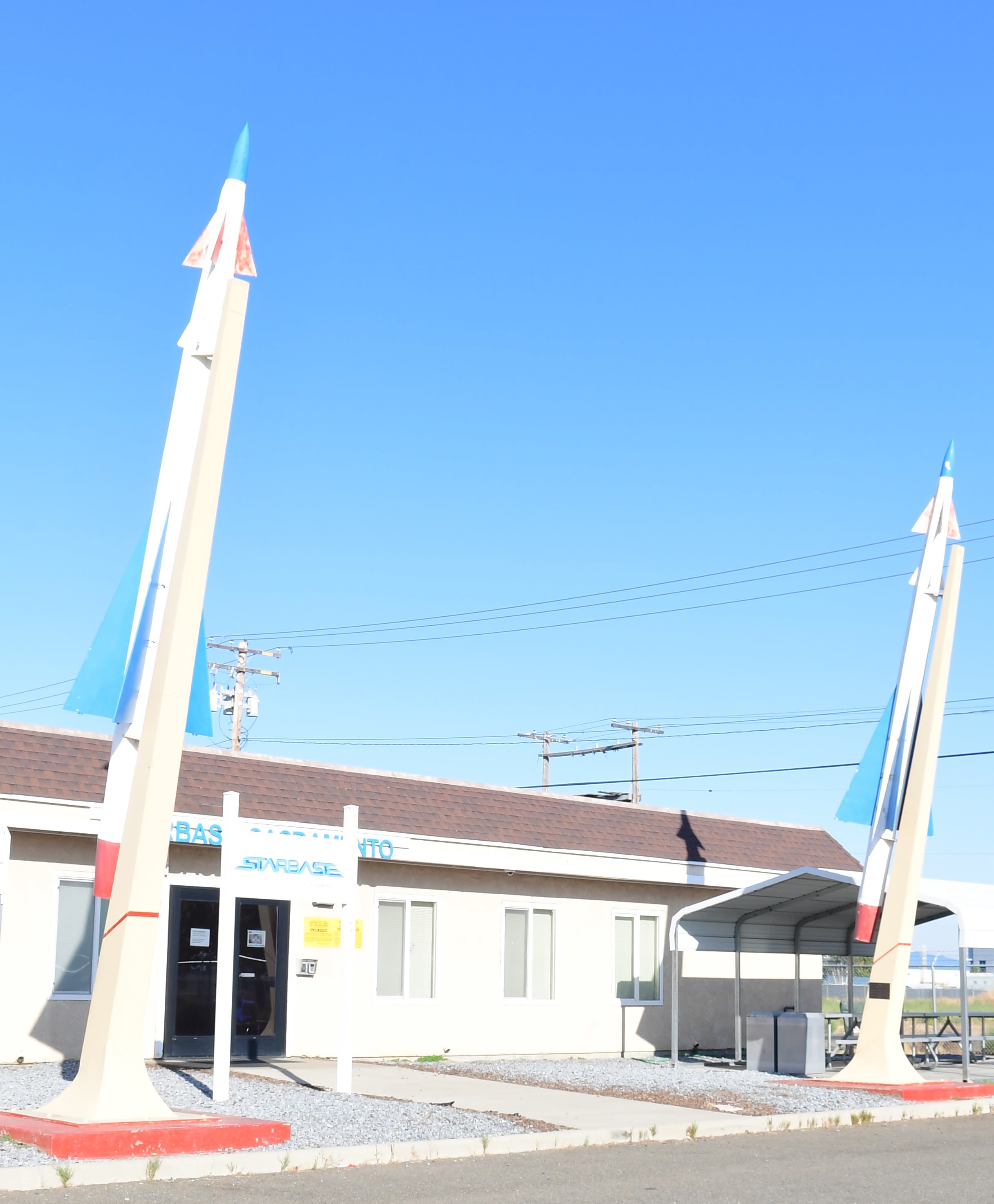 Two rockets stand at building entrance