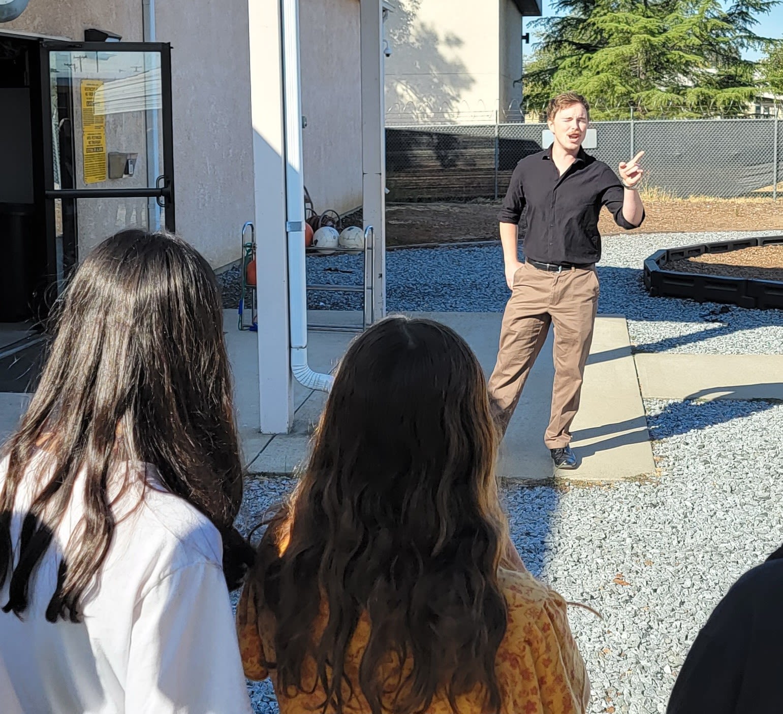 Man addresses group of students