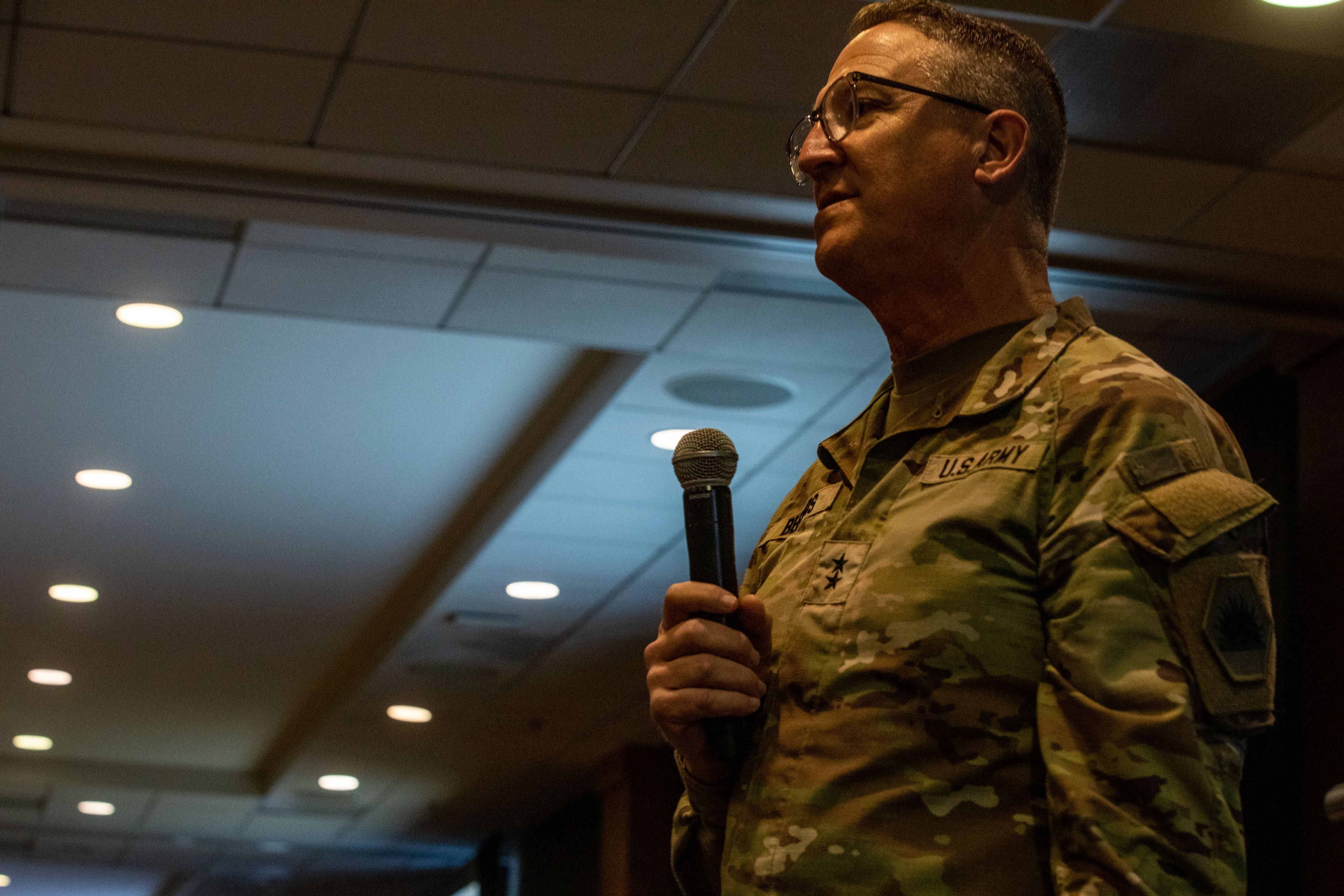 A Soldier speaks into a microphone