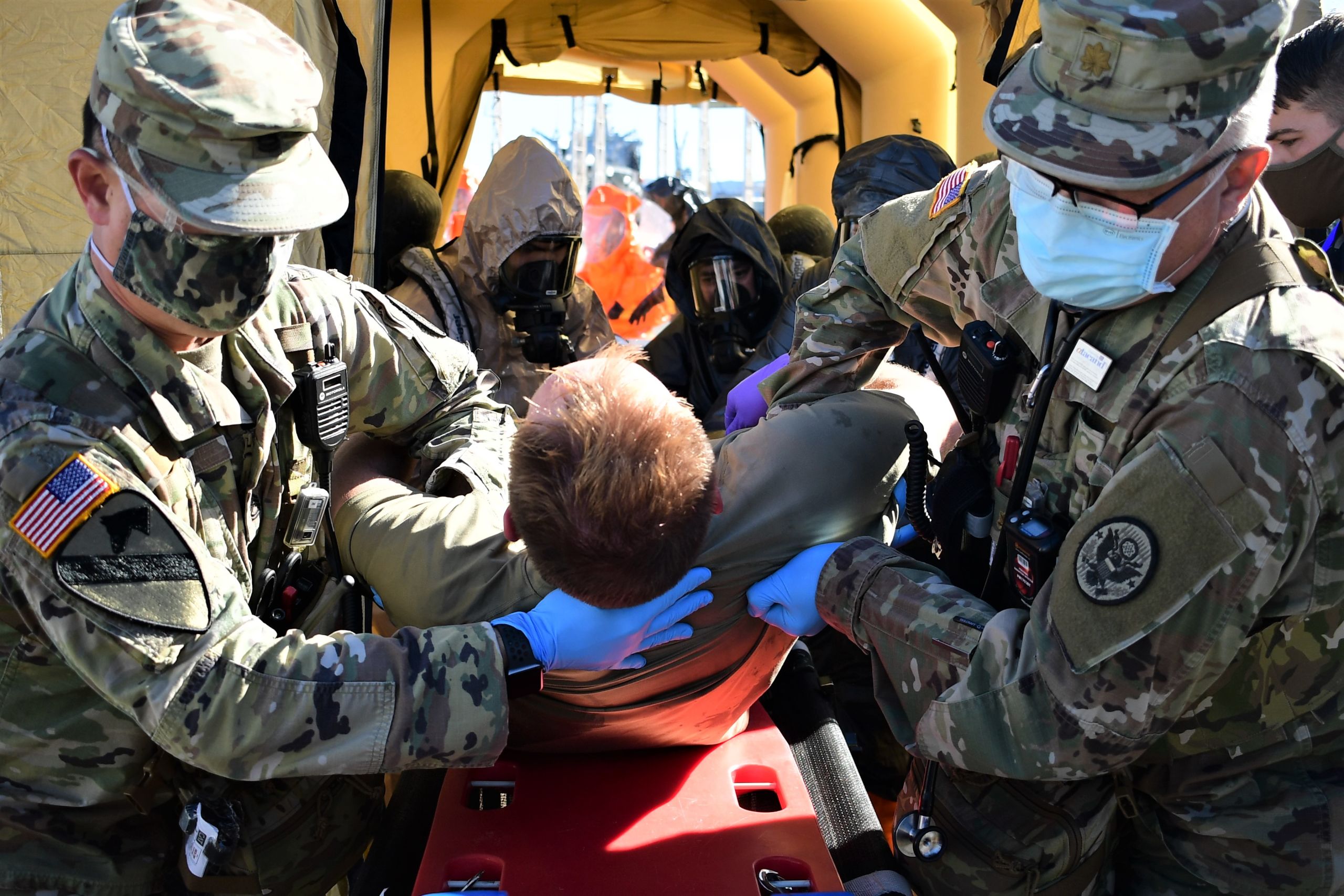 Medical servicemembers treat a fellow colleague during a drill for the exercise.