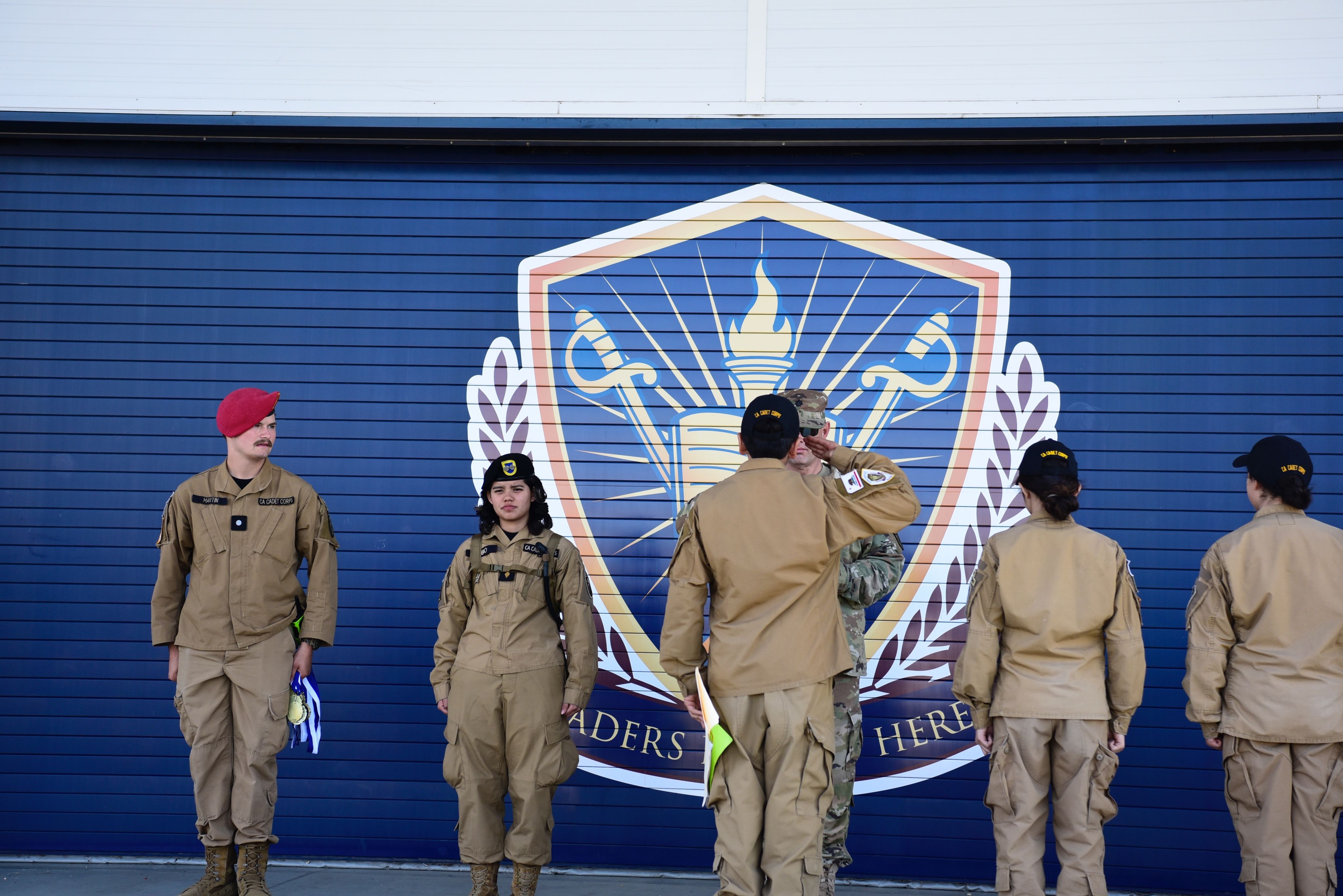 A cadet salutes their leader.